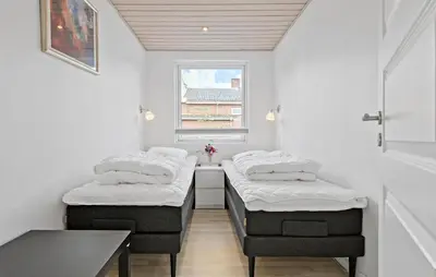 a room with three beds in a room with a window at Amazing Home In Aars With Wifi in Års