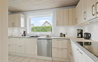 a kitchen with white cabinets and a window at Amazing Home In Aars With Wifi in Års