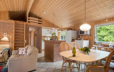a kitchen and living room with a table and chairs at Stunning Home In Brovst With Sauna in Brovst