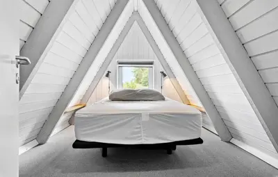 a bed in a white room with a window at Nice Home In Farsø With Kitchen in Farsø