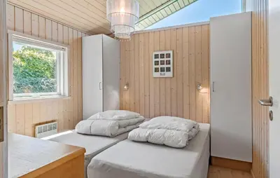 two beds in a room with a window at 3 Bedroom Stunning Home In Løgstrup in Løgstrup