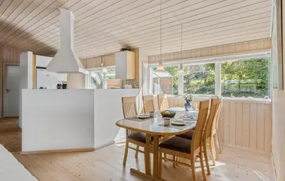 a kitchen and dining room with a table and chairs at 3 Bedroom Stunning Home In Løgstrup in Løgstrup