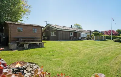 a large yard with a cabin and a fire pit at 3 Bedroom Stunning Home In Løgstrup in Løgstrup