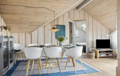 a dining room with a table and white chairs at Cozy Home In Harboøre in Harboør