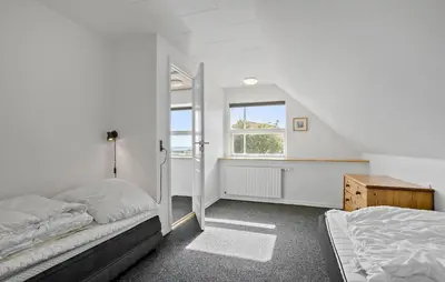 a bedroom with two beds and a window at 3 Bedroom Beautiful Home In Roslev in Roslev