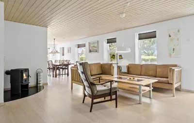 a living room with a couch and a table at 3 Bedroom Beautiful Home In Roslev in Roslev