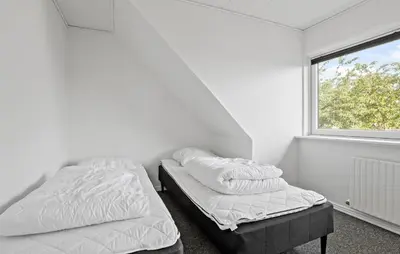 two beds in a white room with a window at 3 Bedroom Beautiful Home In Roslev in Roslev