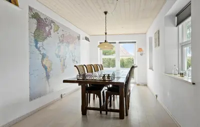 a dining room with a table and a map on the wall at 3 Bedroom Beautiful Home In Roslev in Roslev