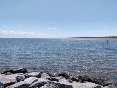 a large body of water with rocks in the water at 5 star holiday home in Vestervig-By Traum in Vestervig