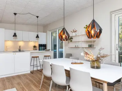 a kitchen and dining room with a white table and chairs at 5 star holiday home in Vestervig-By Traum in Vestervig