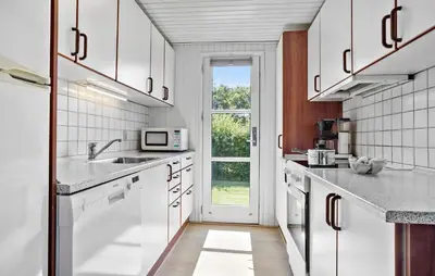 a white kitchen with a sink and a window at Lovely Home In Vestervig With Kitchen in Vestervig