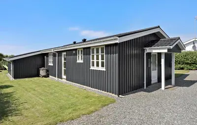 a black house with a yard in front of it at Lovely Home In Vestervig With Kitchen in Vestervig
