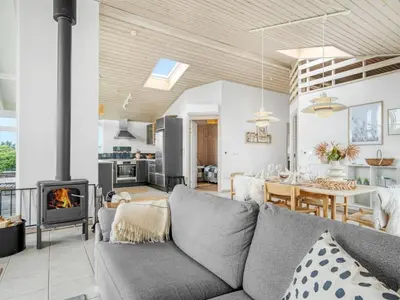 a living room with a couch and a fireplace at Holiday Home Gedda - from the sea by Interhome in Vestervig