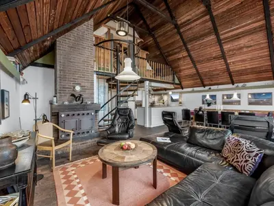 a living room with a couch and a table at Holiday Home Luzy - 75m from the sea by Interhome in Harboør