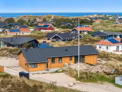 a group of houses on a hill next to the ocean at Holiday Home Helga - 650m from the sea by Interhome in Torsted