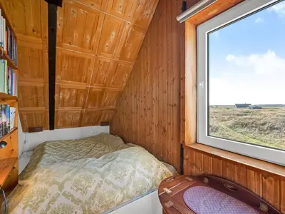 a small room with a bed and a window at Holiday Home Kurt - 75m from the sea by Interhome in Harboør