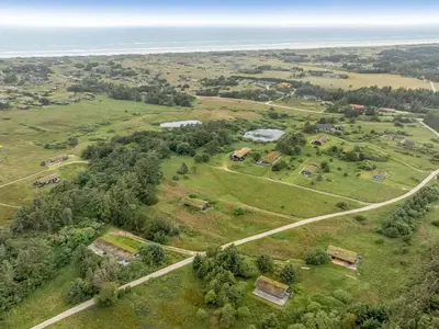 an aerial view of a field with the ocean at Holiday Home Yngve - 1-2km from the sea by Interhome in Løkken