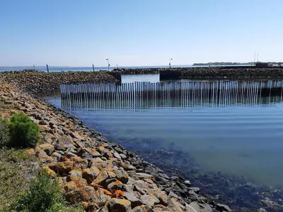 a large body of water next to a pier at Scenic Pool House Retreat - By Traum Ferienwohnungen in Thyholm