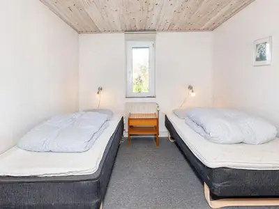 two beds in a room with a desk and a window at Scenic Pool House Retreat - By Traum Ferienwohnungen in Thyholm