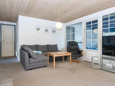a living room with a couch and a table at 4 star holiday home in Harboøre in Harboør