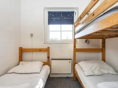 a bedroom with two bunk beds and a window at 4 star holiday home in Harboøre in Harboør