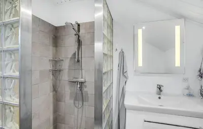 a white bathroom with a shower and a sink at 3 Bedroom Awesome Home In Hurup Thy in Sønder Ydby