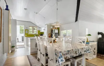a kitchen and dining room with a table and chairs at 3 Bedroom Awesome Home In Hurup Thy in Sønder Ydby