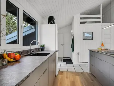 a kitchen with a sink and a refrigerator at Holiday Home Annlisa - 1km from the sea by Interhome in Blokhus