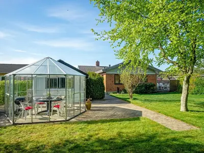 a greenhouse in the yard of a house at Holiday Home Satu - 2km from the sea by Interhome in Blokhus