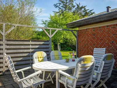 a white table and chairs on a patio at Holiday Home Satu - 2km from the sea by Interhome in Blokhus
