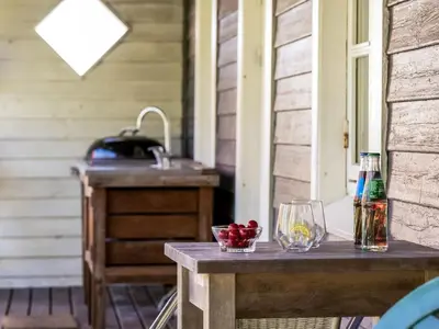 a table on a porch with a sink and fruit on it at Holiday Home Ejnarine - 600m to the fjord by Interhome in Farsø