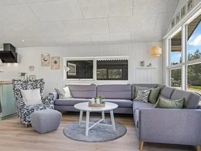 a living room with a purple couch and a table at Holiday Home Ema - 1-9km from the sea by Interhome in Saltum