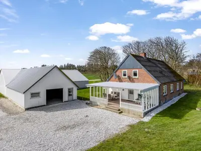 a barn conversion with a garage and a house at Holiday Home Kerrin - 1km from the sea by Interhome in Hanstholm