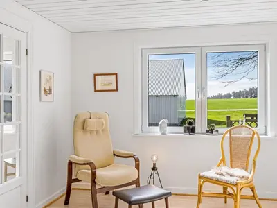 a living room with two chairs and a window at Holiday Home Kerrin - 1km from the sea by Interhome in Hanstholm