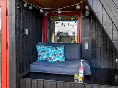 a blue couch sitting on the back of a porch at Holiday Home Erly - 18km to the fjord by Interhome in Farsø