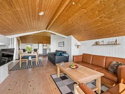 a living room with a couch and a table at Holiday Home Emppu - 250m from the sea by Interhome in Harboør