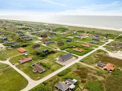 an aerial view of a housing estate next to the ocean at Holiday Home Emppu - 250m from the sea by Interhome in Harboør