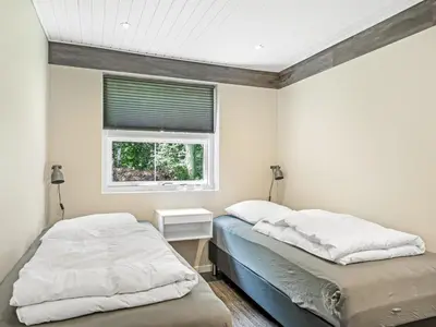two beds in a bedroom with a window at Holiday Home Skip - 300m to the fjord by Interhome in Højslev