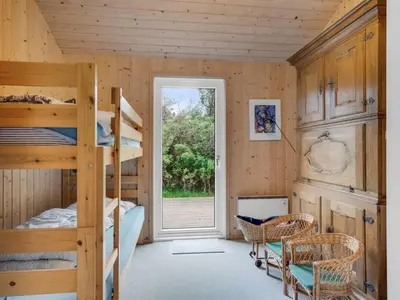 a bedroom with two bunk beds and a window at Holiday Home Sella - 200m from the sea by Interhome in Torsted
