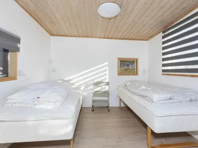 two beds in a room with a wooden ceiling at 8 person holiday home in Hurup Thy-By Traum in Sindrup