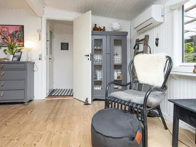 a living room with a chair and a table at 5 person holiday home in Thyholm-By Traum in Thyholm