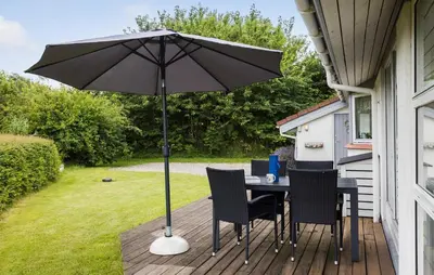 a table and chairs with an umbrella on a deck at 3 Bedroom Gorgeous Home In Fur in Furland