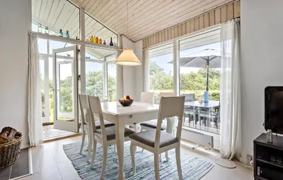 a dining room with a white table and chairs at 3 Bedroom Gorgeous Home In Fur in Furland