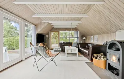 a living room with a couch and a fireplace at 2 Bedroom Beautiful Home In Farsø in Farsø