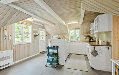 a kitchen with white cabinets and a wooden ceiling at 2 Bedroom Beautiful Home In Farsø in Farsø
