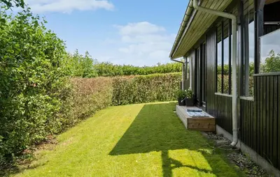 a yard with a bench on the side of a house at 3 Bedroom Cozy Home In Vinderup in Vinderup