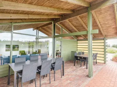 an outdoor patio with a table and chairs at 12 person holiday park home in Hanstholm in Hanstholm