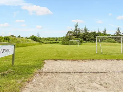 a soccer field with a sign next to a goal at 12 person holiday park home in Hanstholm in Hanstholm