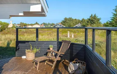a patio with two chairs and a table on a deck at 2 Bedroom Lovely Home In Thisted in Thisted