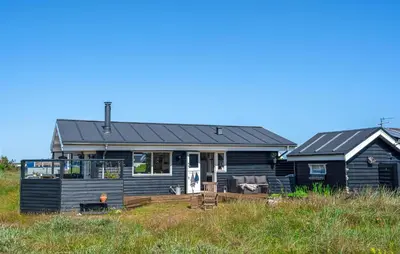 a black house with a deck and a house at 2 Bedroom Lovely Home In Thisted in Thisted